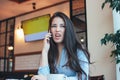 Beautiful charming brunette angry asian girl talking and arguing with someone on the phone Royalty Free Stock Photo