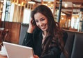 Beautiful charming brunette happy asian girl with tablet at table in cafe, student, freelancer or young manager Royalty Free Stock Photo