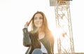 Beautiful charming brunette long hair happy asian girl in black leather jacket at sunset Royalty Free Stock Photo