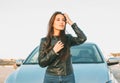 Happpy beautiful charming brunette long hair young asian woman in black leather jacket near her car Royalty Free Stock Photo