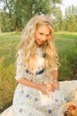 Beautiful charming long curly blonde hair teenage girl wearing a