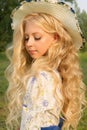 Beautiful charming long curly blonde hair teenage girl wearing a