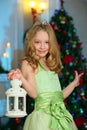 Beautiful charming pretty blond child-girl on the background of a New Year tree Royalty Free Stock Photo