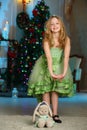 Pretty blond child-girl on the background of a New Year tree Royalty Free Stock Photo