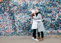 Beautiful charming smiling young teenage girls two sisters having fun posing against a colorful bright wall Royalty Free Stock Photo