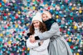 Beautiful charming smiling young teenage girls two sisters having fun posing against a colorful bright wall Royalty Free Stock Photo