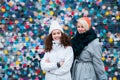 Beautiful charming smiling young teenage girls two sisters having fun posing against a colorful bright wall Royalty Free Stock Photo