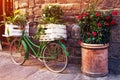 Beautiful charming street landscape with an old bike with flowers in boxes in the middle of an ancient street on a cobblestone