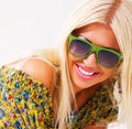 Beautiful cheerful blonde in green sunglasses Royalty Free Stock Photo