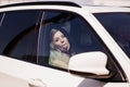 A beautiful and cheerful bride shows the tongue in cars. Rent transport