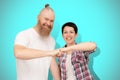 Beautiful cheerful happy couple 40s bumping fists standing on blue background. Family unity and partnership concept Royalty Free Stock Photo