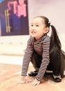 Beautiful cheerful little girl playing pleasure ground on playground Royalty Free Stock Photo