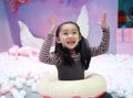 Beautiful cheerful little girl playing pleasure ground on playground Royalty Free Stock Photo