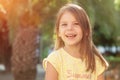 Beautiful cheerful little girl is smiling and looking at the cam Royalty Free Stock Photo