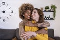 Beautiful and cheerful multiracial lesbian couple hugging and looking each other smiling. Lovely and happy homosexual