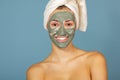 Beautiful cheerful teen girl applying facial clay mask. Beauty treatments Royalty Free Stock Photo