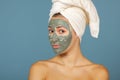 Beautiful cheerful teen girl applying facial clay mask. Beauty treatments Royalty Free Stock Photo