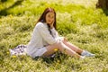 Beautiful cheerful young brunette woman in green park and smiling to camera. Royalty Free Stock Photo