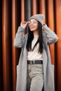 Beautiful cheerful young hipster woman with cute smile in fashionable clothes straightens glasses. Fashion portrait happy girl Royalty Free Stock Photo