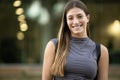 Beautiful cheerful young lady looking at camera standing outside.Joyful blond woman staring at camera in the street. Royalty Free Stock Photo