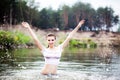 Beautiful cheerful young woman bathes in lake Royalty Free Stock Photo