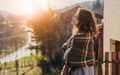 Beautiful cheerful young woman enjoying the sunset and nature with closed eyes on the terrace of a country house Royalty Free Stock Photo