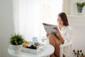 Beautiful young woman reading magazine at home Royalty Free Stock Photo