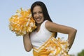 Beautiful Cheerleader Holding Pom-Poms