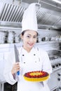 Chef holds knife and dessert Royalty Free Stock Photo