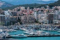 A large number of expensive yachts and boats on the pier near the coast of the beautiful resort town