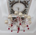 Beautiful large chandelier weighs in the background of a beautiful ceiling Royalty Free Stock Photo