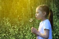 Beautiful child blowing away dandelion flower in spring. Royalty Free Stock Photo