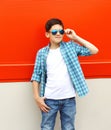 Beautiful child boy wearing a sunglasses and shirt over red Royalty Free Stock Photo