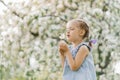 Beautiful child with dandelion flower. Happy kid having fun outdoors in spring park Royalty Free Stock Photo