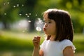 Beautiful child with dandelion flower in spring park. Happy kid having fun outdoors. Royalty Free Stock Photo