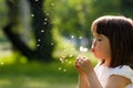 Beautiful child with dandelion flower in spring park. Happy kid having fun outdoors. Royalty Free Stock Photo