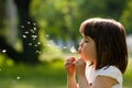 Beautiful child with dandelion flower in spring park. Happy kid having fun outdoors. Royalty Free Stock Photo