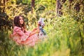 Beautiful child girl dressed as fairytale princess playing with doll in summer forest Royalty Free Stock Photo