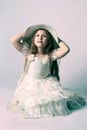 Beautiful child girl in elegant dress and hat.