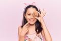 Beautiful child girl holding cookie smiling happy pointing with hand and finger Royalty Free Stock Photo