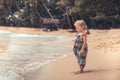 Beautiful child girl looking into the sea on beach tropical island during summer holidays concept carefree childhood travel lifest Royalty Free Stock Photo