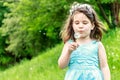 Beautiful child girl in park. Happy kid having fun outdoo Royalty Free Stock Photo