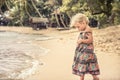 Beautiful child girl walking on beach tropical island during summer holidays concept carefree childhood travel lifestyle Royalty Free Stock Photo