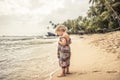 Beautiful child girl walking on beach tropical island during summer holidays concept carefree childhood travel lifestyle Royalty Free Stock Photo