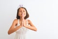 Beautiful child girl wearing princess crown standing over isolated white background begging and praying with hands together with Royalty Free Stock Photo