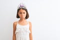 Beautiful child girl wearing princess crown standing over isolated white background depressed and worry for distress, crying angry Royalty Free Stock Photo