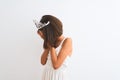 Beautiful child girl wearing princess crown standing over isolated white background with sad expression covering face with hands Royalty Free Stock Photo