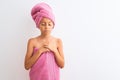 Beautiful child girl wearing shower towel after bath standing over isolated white background depressed and worry for distress, Royalty Free Stock Photo