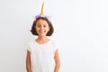 Beautiful child girl wearing unicorn diadem standing over isolated white background with a happy and cool smile on face Royalty Free Stock Photo