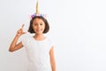 Beautiful child girl wearing unicorn diadem standing over isolated white background smiling and confident gesturing with hand Royalty Free Stock Photo